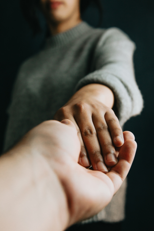 An image of a therapist holding the patient's hand